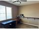 Bright office space featuring a window, desk, and built-in shelving unit at 21544 W Watkins St, Buckeye, AZ 85326