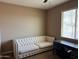 Well-lit home office featuring a tufted sofa and a desk at 21544 W Watkins St, Buckeye, AZ 85326