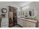 Bright bathroom featuring double sinks, neutral countertops, and a walk-in closet at 2579 E Camellia Dr, Gilbert, AZ 85296