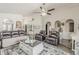 Bright living room with neutral colors, hardwood floors, ceiling fan, arched doorways, and comfortable seating at 2579 E Camellia Dr, Gilbert, AZ 85296