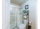 Bright bathroom with a glass shower, decorative shelf and modern fixtures at 2725 E Mine Creek Rd # 1208, Phoenix, AZ 85024