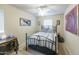 Charming bedroom with a wrought iron bed frame, neutral walls, and natural light from the windows at 2725 E Mine Creek Rd # 1208, Phoenix, AZ 85024