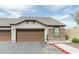 Attached garage doors, stone accents, and well-maintained landscaping enhance this beautiful home at 2725 E Mine Creek Rd # 1208, Phoenix, AZ 85024