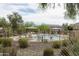 Community pool with lounge chairs and shaded seating areas surrounded by desert landscaping at 2725 E Mine Creek Rd # 1208, Phoenix, AZ 85024