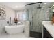 Elegant bathroom featuring a standalone tub, luxurious marble finishes, and a frameless glass shower at 2802 E Mercer Ln, Phoenix, AZ 85028