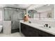 Spa-like bathroom featuring dual sinks, marble countertops, modern fixtures, and a glass-enclosed shower at 2802 E Mercer Ln, Phoenix, AZ 85028