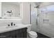 Modern bathroom featuring a sleek vanity, marble countertops, black fixtures, and a glass-enclosed shower at 2802 E Mercer Ln, Phoenix, AZ 85028