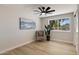 Comfortable bedroom featuring laminate floors, a decorative chair, and natural light from the window at 2802 E Mercer Ln, Phoenix, AZ 85028