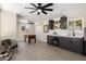 Spacious bonus room featuring a stylish bar, game table, ceiling fans, and large windows at 2802 E Mercer Ln, Phoenix, AZ 85028