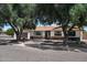 Charming single-story home with stone accents, mature trees, and a well-maintained front yard at 2802 E Mercer Ln, Phoenix, AZ 85028