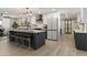 Spacious kitchen with white cabinets, modern appliances, a center island, and barn door access at 2802 E Mercer Ln, Phoenix, AZ 85028