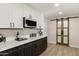 Beautiful kitchen with modern cabinetry, stainless steel appliances, and barn door to another room at 2802 E Mercer Ln, Phoenix, AZ 85028