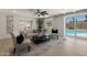 Inviting living room featuring stylish furnishings, a ceiling fan, and sliding glass doors to the backyard and pool at 2802 E Mercer Ln, Phoenix, AZ 85028