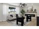 Cozy living room with a fireplace, ample natural light, comfortable seating, and a view to the street at 2802 E Mercer Ln, Phoenix, AZ 85028