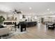 Bright, open-concept living room with modern fireplace, sleek furniture, and a view of the kitchen at 2802 E Mercer Ln, Phoenix, AZ 85028