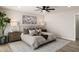 Well-lit main bedroom showcasing a plush bed, stylish decor, a ceiling fan, and laminate floors at 2802 E Mercer Ln, Phoenix, AZ 85028