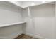 Functional walk-in closet with ample shelving and metal hanging racks, providing efficient storage space at 2802 E Mercer Ln, Phoenix, AZ 85028