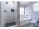 Bathroom with separate tub and shower featuring updated fixtures, tile surround, and window with white blinds at 29891 N Desert Angel Dr, San Tan Valley, AZ 85143
