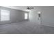Spacious, neutral toned bedroom featuring carpeted floor and two windows with white blinds at 29891 N Desert Angel Dr, San Tan Valley, AZ 85143