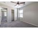 Neutral toned bedroom featuring carpeted floor, ceiling fan and closet with standard sliding door, and window with white blinds at 29891 N Desert Angel Dr, San Tan Valley, AZ 85143