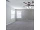 Neutral toned bedroom with carpeted floor, ceiling fan, and windows with white blinds at 29891 N Desert Angel Dr, San Tan Valley, AZ 85143