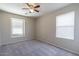 Spacious neutral toned bedroom featuring carpeted floor and two windows with white blinds at 29891 N Desert Angel Dr, San Tan Valley, AZ 85143