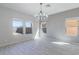 Bright dining area features tile floors, big windows offering lots of natural light, and a modern chandelier at 29891 N Desert Angel Dr, San Tan Valley, AZ 85143