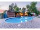 Backyard pool with brick surround and covered patio offers an oasis for relaxation and entertaining in style at 301 W Royal Palm Rd, Phoenix, AZ 85021