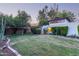 Landscaped backyard with a well-maintained lawn and mature trees at 301 W Royal Palm Rd, Phoenix, AZ 85021