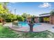 Backyard pool with stone trim, manicured lawn, a sitting bench and covered patio for lounging and entertaining at 301 W Royal Palm Rd, Phoenix, AZ 85021
