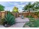 Backyard patio with brick border, a hammock, and lush plants offers a relaxing outdoor space at 301 W Royal Palm Rd, Phoenix, AZ 85021