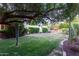 Spacious backyard with a lush lawn, mature trees, and a swimming pool at 301 W Royal Palm Rd, Phoenix, AZ 85021