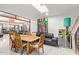 Bright dining area features natural lighting from skylight, dining table with seating and access to multiple rooms at 301 W Royal Palm Rd, Phoenix, AZ 85021
