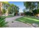 Modern single-story home with a low-pitched roof, desert landscaping, and a charming brick driveway at 301 W Royal Palm Rd, Phoenix, AZ 85021