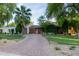 Beautiful single-Gathering home with lush landscaping, brick accent wall, and a brick paved driveway at 301 W Royal Palm Rd, Phoenix, AZ 85021