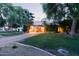 View of home featuring a lush green lawn, a brick driveway and mature trees at 301 W Royal Palm Rd, Phoenix, AZ 85021