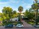 Charming home with a brick driveway, green lawn, and palm trees at 301 W Royal Palm Rd, Phoenix, AZ 85021