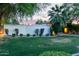 Long wall of manicured hedges and green lawn surrounding the house at 301 W Royal Palm Rd, Phoenix, AZ 85021
