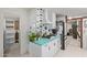 Bright kitchen featuring retro turquoise countertops, sleek white cabinetry, and modern appliances at 301 W Royal Palm Rd, Phoenix, AZ 85021