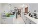 Bright kitchen featuring white cabinets, subway backsplash, skylight, and an open design at 301 W Royal Palm Rd, Phoenix, AZ 85021