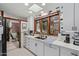 Bright, streamlined kitchen boasts modern appliances, white cabinetry, and a window overlooking the outdoors at 301 W Royal Palm Rd, Phoenix, AZ 85021