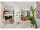 Open-concept living area with views to dining room and front entrance, skylight, and decorative artwork at 301 W Royal Palm Rd, Phoenix, AZ 85021