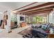 Bright living room featuring beamed ceilings, a cozy fireplace, comfortable seating, and lots of windows at 301 W Royal Palm Rd, Phoenix, AZ 85021