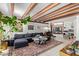 Spacious living room with beamed ceilings, skylight, comfortable seating, and stylish décor at 301 W Royal Palm Rd, Phoenix, AZ 85021