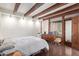 A spacious bedroom features exposed beams, hardwood floors, a full bed, and ample closet space at 301 W Royal Palm Rd, Phoenix, AZ 85021