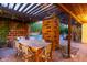 Outdoor dining area under a pergola with a view of the pool at 301 W Royal Palm Rd, Phoenix, AZ 85021