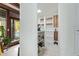 Walk-in pantry features custom shelving, ample storage space, and easy access to the adjacent outdoor patio area at 301 W Royal Palm Rd, Phoenix, AZ 85021