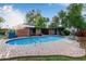 Backyard pool featuring a diving board, brick trim, manicured lawn, and covered patio for entertaining and relaxation at 301 W Royal Palm Rd, Phoenix, AZ 85021