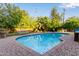 Backyard pool with brick surround, green lawn and mature trees provides a relaxing outdoor oasis at 301 W Royal Palm Rd, Phoenix, AZ 85021