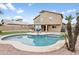 A large backyard with a kidney shaped pool, basketball court, and desert landscaping at 3126 W Stephens Pl, Chandler, AZ 85226